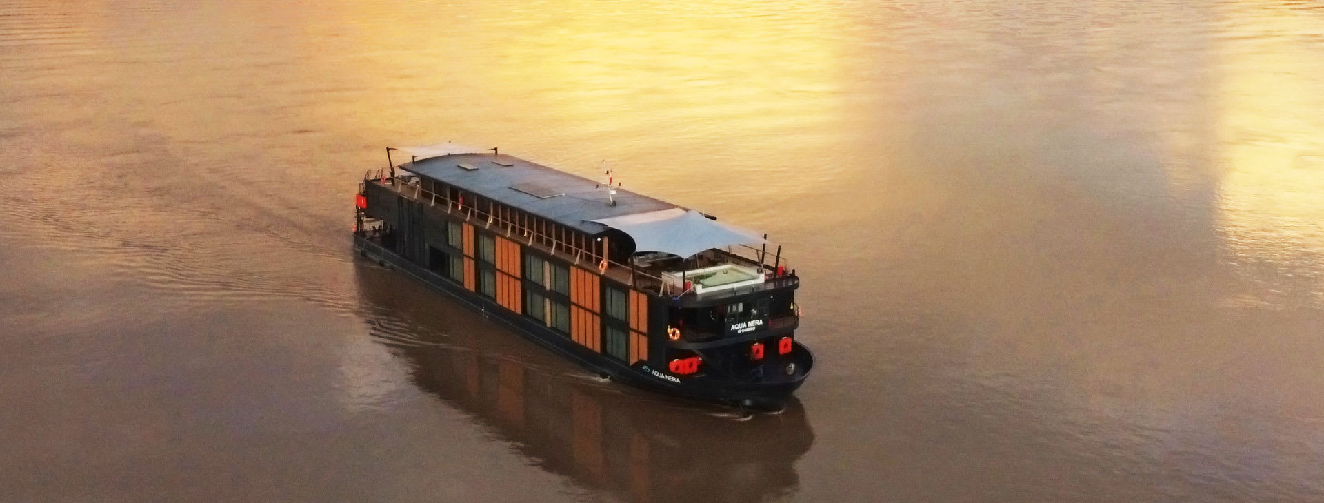Ship on the Amazon river at sunset