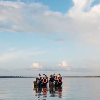 People in skiffs on the big river