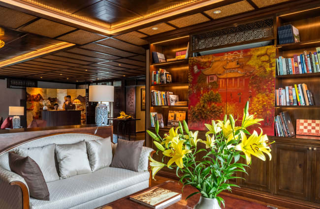 Library with sofa and flowers