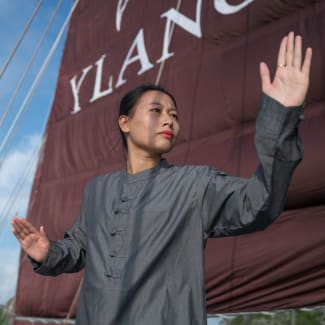 Woman doing Tai Chi on the deck